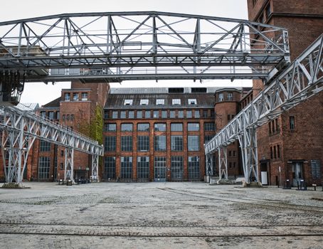 Historic brick industrial building with iron framework in Berlin, Germany.