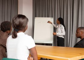 Business professionals engaged in a team meeting with a presentation on teamwork.